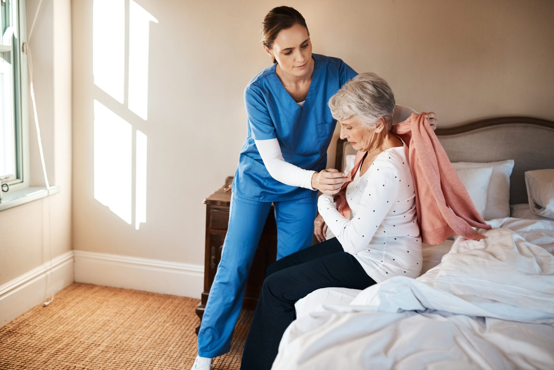 nurse, old woman and dressing in bedroom, support and trust with rehabilitation, recovery and healing. house, medical and professional with patient, caregiver and health with assistance with clothes